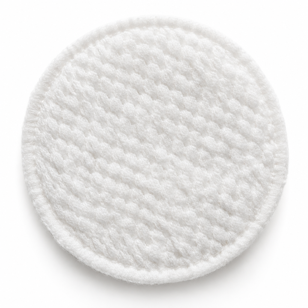 Close-up macro of exfoliating cleansing pad surface showing soft cotton texture and gentle exfoliating fibers
